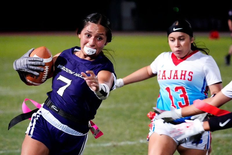 Shadow Hills’ Xitlalli Fregoso, left, runs the ball as Indio's Kruzephyr Polanco (7) defends during the flag football game in Indio, Calif., on Monday, August 25, 2025.