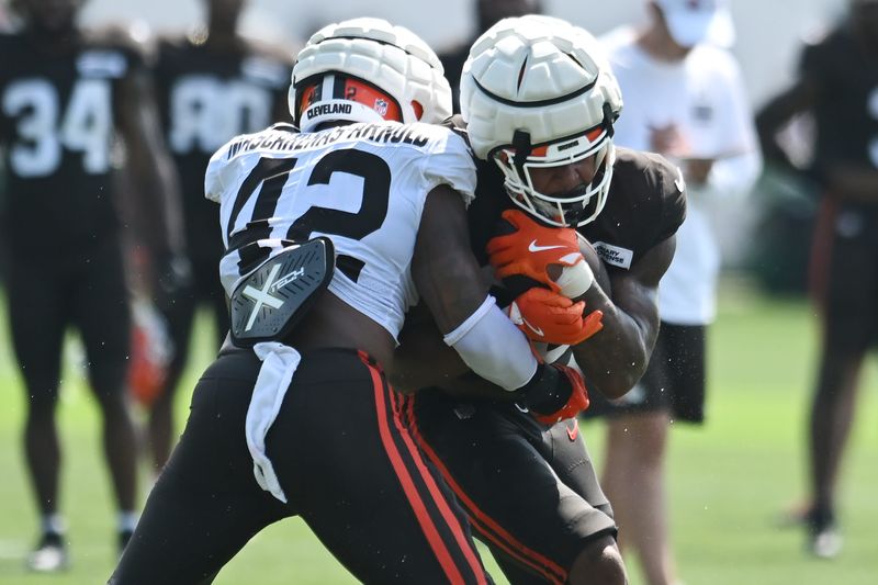 Jul 28, 2025; Berea, OH, USA; Cleveland Browns linebacker Easton Mascarenas-Arnold (42) hist running back Ahmani Marshall (39) during training camp at CrossCountry Mortgage Campus. Mandatory Credit: Ken Blaze-Imagn Images