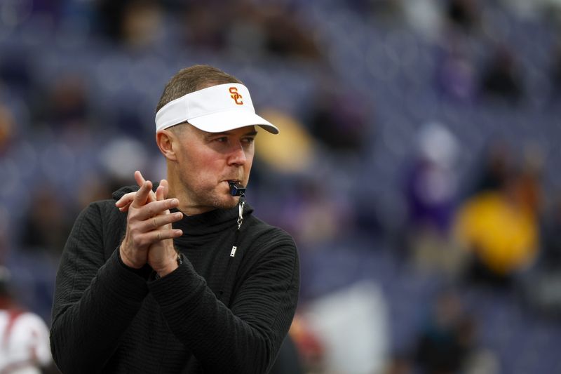 Nov 2, 2024; Seattle, Washington, USA; USC Trojans head coach Lincoln Riley watches pregame warmups against the Washington Huskies at Alaska Airlines Field at Husky Stadium. Mandatory Credit: Joe Nicholson-Imagn Images
