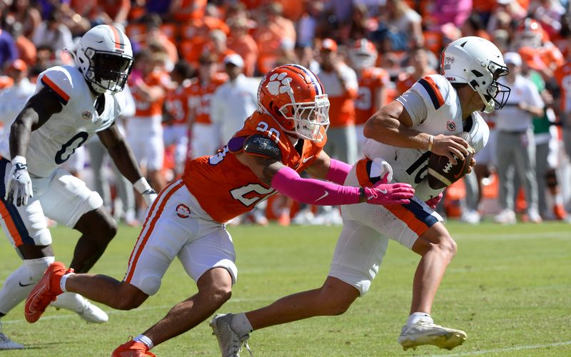 Oct 19, 2024; Clemson, South Carolina, USA; Clemson Tigers corner back Avieon Terrell (20) attempts to tackle Virginia Cavaliers Anthony Colandrea (10) during their game at Memorial Stadium. Mandatory Credit: Alexander Hicks-Imagn Images