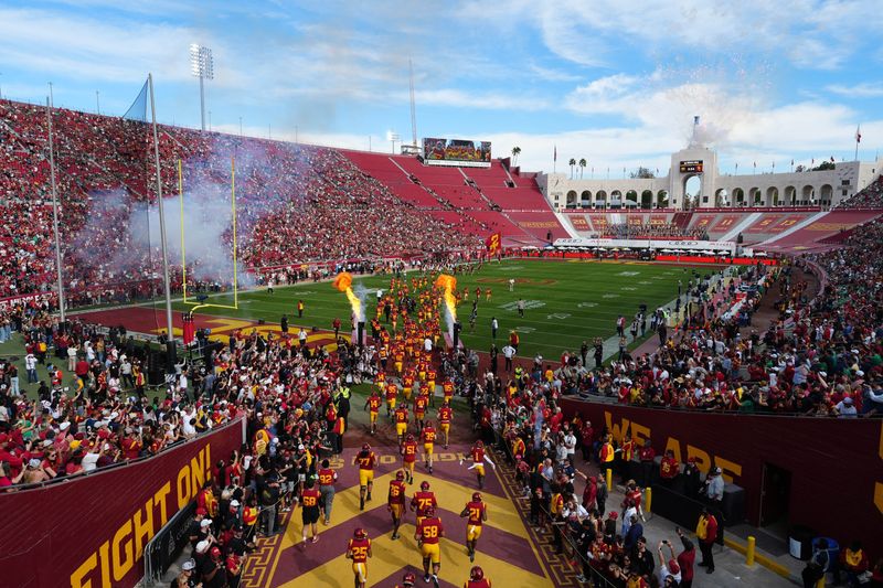 Nov 30, 2024; Los Angeles, California, USA; A general overall view as Southern California Trojans players enter the field before the game against the Notre Dame Fighting Irish at United Airlines Field at Los Angeles Memorial Coliseum. Mandatory Credit: Kirby Lee-Imagn Images
