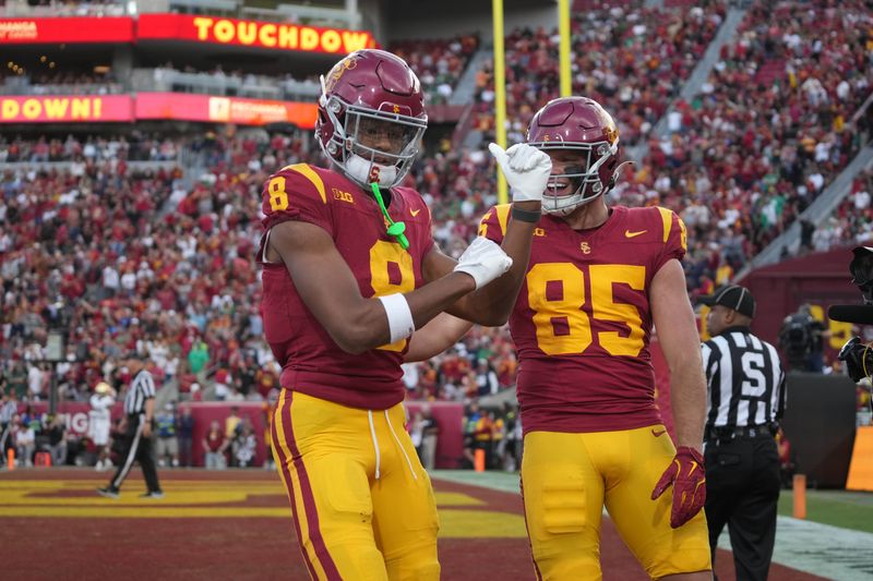 Nov 30, 2024; Los Angeles, California, USA; Southern California Trojans wide receiver Ja'Kobi Lane (8) celebrates with tight end Walker Lyons (85) after scoring on a 6-yard touchdown reception against the Notre Dame Fighting Irish in the second half at United Airlines Field at Los Angeles Memorial Coliseum. Mandatory Credit: Kirby Lee-Imagn Images