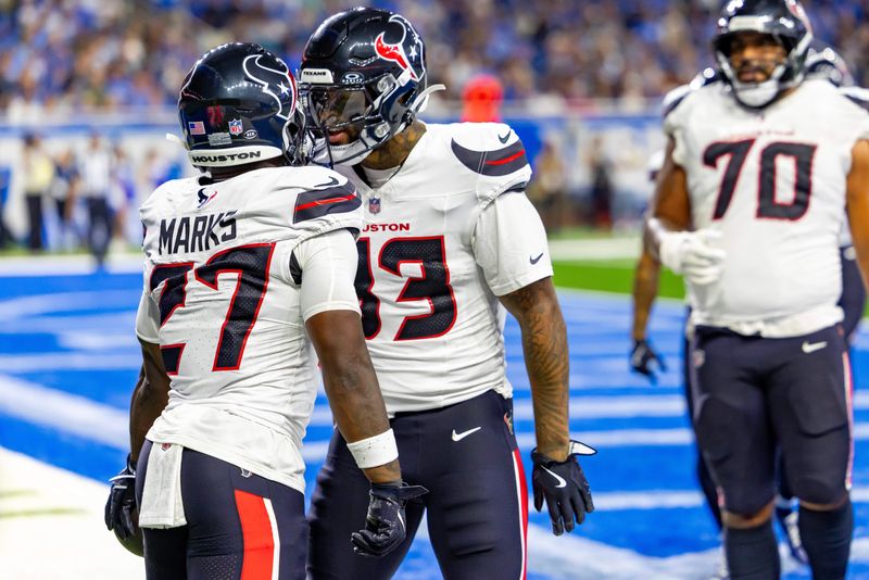 Aug 23, 2025; Detroit, Michigan, USA; Houston Texans running back Woody Marks (27) celebrates his touchdown with teammate tight end Irv Smith Jr. (83) during the first half against the Detroit Lions at Ford Field. Mandatory Credit: David Reginek-Imagn Images