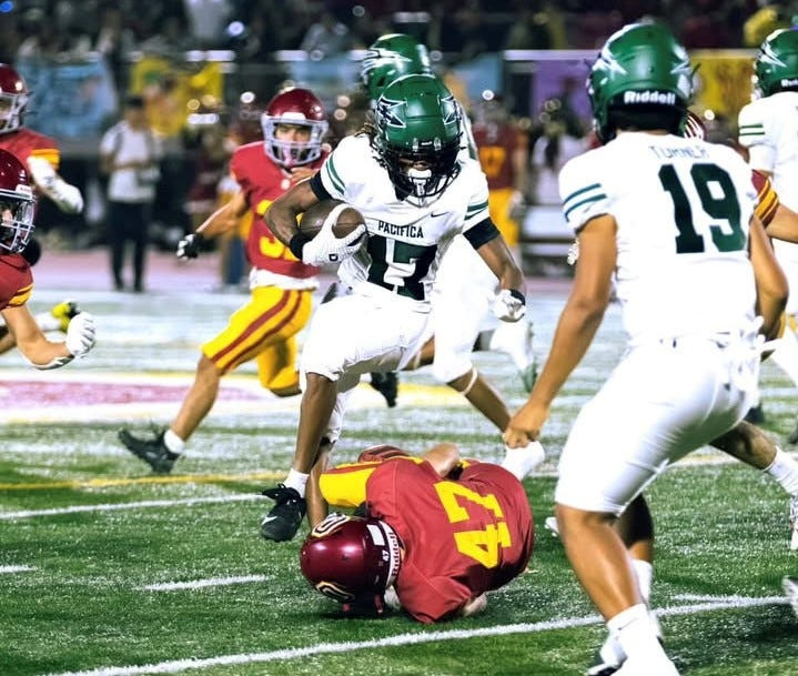 Pacifica High's Gabriel Marquez leaps over Oxnard's Alder Kubic during the Tritons' 62-0 win in a nonleague game at Oxnard High on Friday, Aug. 29, 2025.