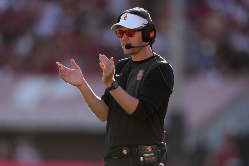 Aug 30, 2025; Los Angeles, California, USA; Southern California Trojans head coach Lincoln Riley watches from the sidelines against the Missouri State Bears in the first half at United Airlines Field at Los Angeles Memorial Coliseum. Mandatory Credit: Kirby Lee-Imagn Images