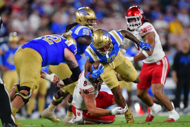 Aug 30, 2025; Pasadena, California, USA; UCLA Bruins quarterback Nico Iamaleava (9) moves the ball against Utah Utes linebacker Lander Barton (8) during the first half at Rose Bowl. Mandatory Credit: Gary A. Vasquez-Imagn Images