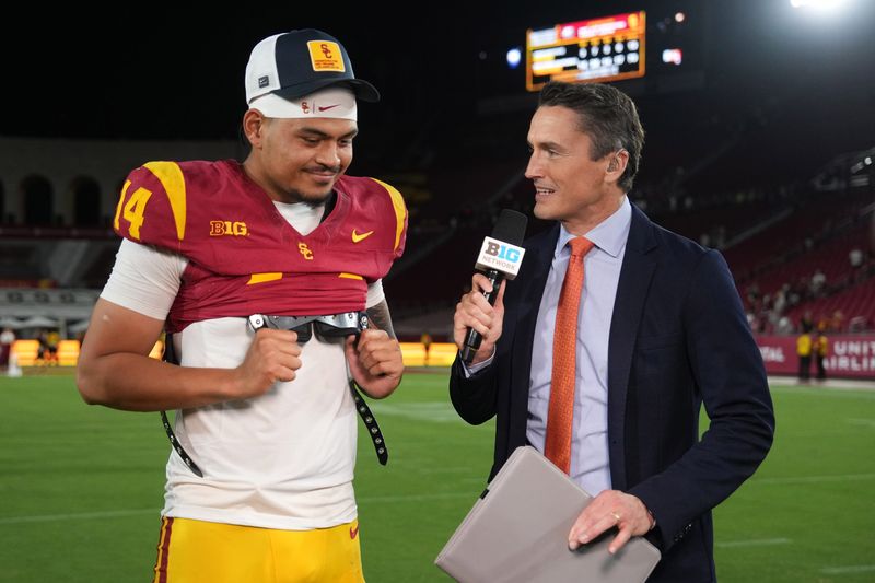 Aug 30, 2025; Los Angeles, California, USA; Big Ten Network reporter Rhett Lewis (right) interviews Southern California Trojans quarterback Jayden Maiava (14) after the game against the Missouri State Bears at United Airlines Field at Los Angeles Memorial Coliseum. Mandatory Credit: Kirby Lee-Imagn Images