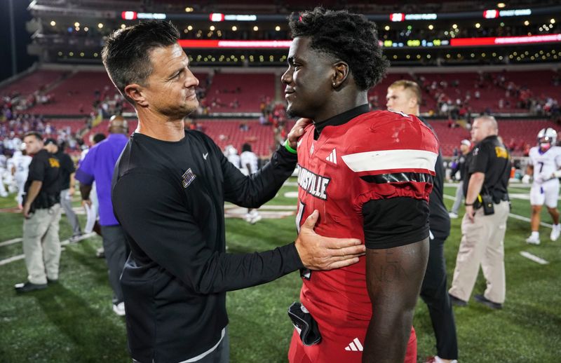James Madison University head coach Bob Chesney congratulated Louisville Cardinals running back Isaac Brown (1) on his running game after the Cards defeated the Dukes 28-14 Friday September 5, 2025 at L&N Federal Credit Union Stadium in Louisville, Kentucky.