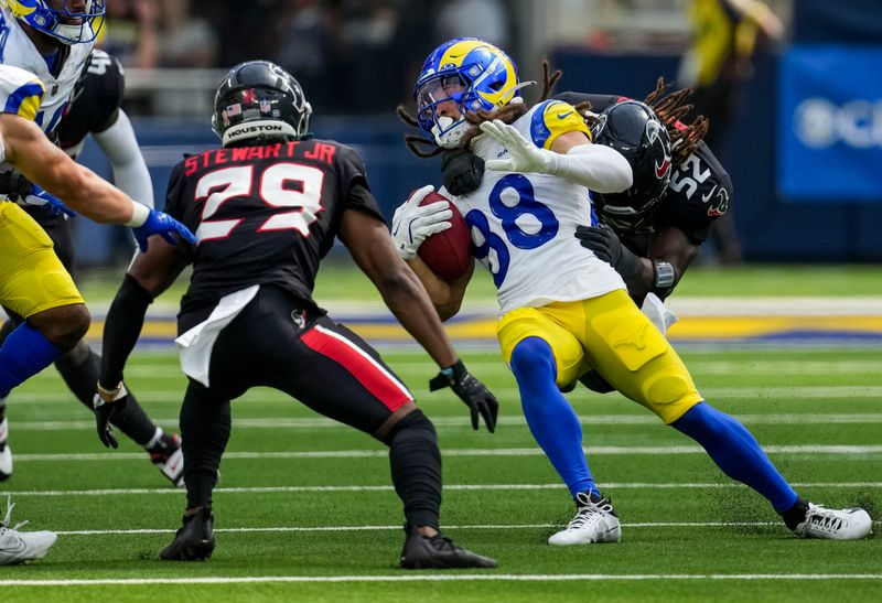 Sep 7, 2025; Inglewood, California, USA; Houston Texans defensive end Darrell Taylor (52) tackles Los Angeles Rams wide receiver Jordan Whittington (88) during the third quarter at SoFi Stadium. Mandatory Credit: Kirby Lee-Imagn Images