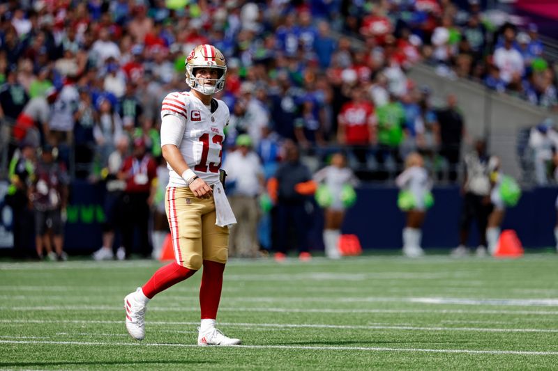 Sep 7, 2025; Seattle, Washington, USA; San Francisco 49ers quarterback Brock Purdy (13) looks on during the first half against the Seattle Seahawks at Lumen Field. Mandatory Credit: Joe Nicholson-Imagn Images