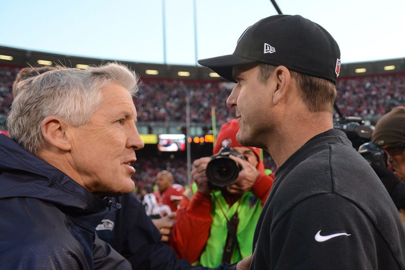 San Francisco, CA, USA; Seattle Seahawks head coach Pete Carroll (left) shakes hands with San Francisco 49ers head coach Jim Harbaugh (right) after the game at Candlestick Park. The 49ers defeated the Seahawks 19-17. Mandatory Credit: Kyle Terada-USA TODAY Sports