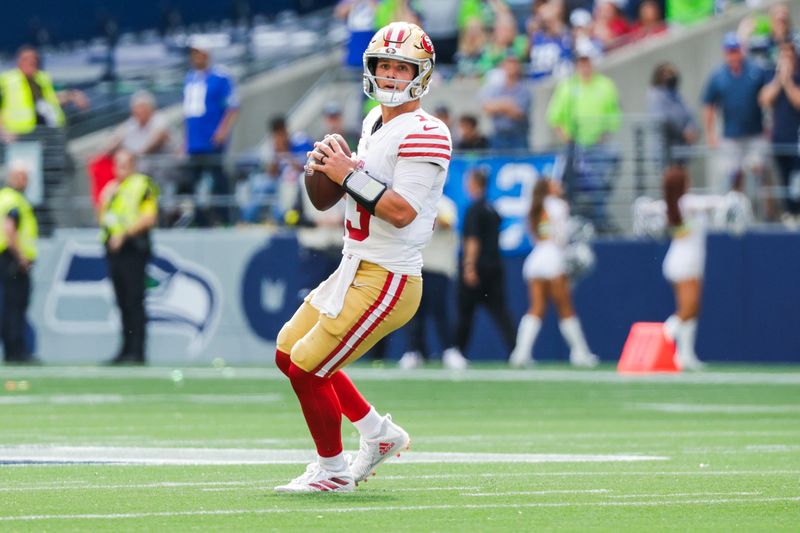 Sep 7, 2025; Seattle, Washington, USA; San Francisco 49ers quarterback Brock Purdy (13) looks to pass against the Seattle Seahawks during the third quarter at Lumen Field. Mandatory Credit: Joe Nicholson-Imagn Images