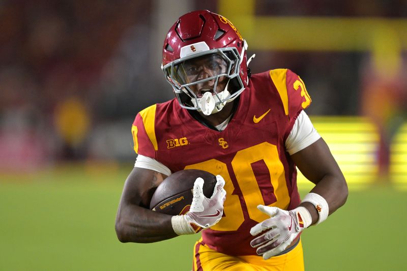 Sep 6, 2025; Los Angeles, California, USA; USC Trojans running back King Miller (30) carries the ball down the field for a touchdown in the second half against the Georgia Southern Eagles at the Los Angeles Memorial Coliseum. Mandatory Credit: Jayne Kamin-Oncea-Imagn Images