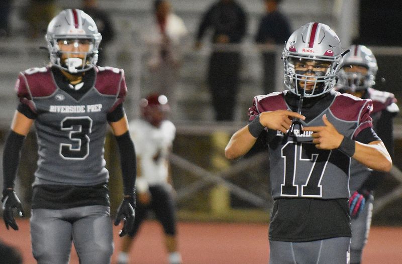 Riverside Prep quarterback Daniel Gutierrez goes over the play call during the fourth quarter against Indian Springs on Thursday, Sept. 11, 2025. Riverside Prep lost 41-0.