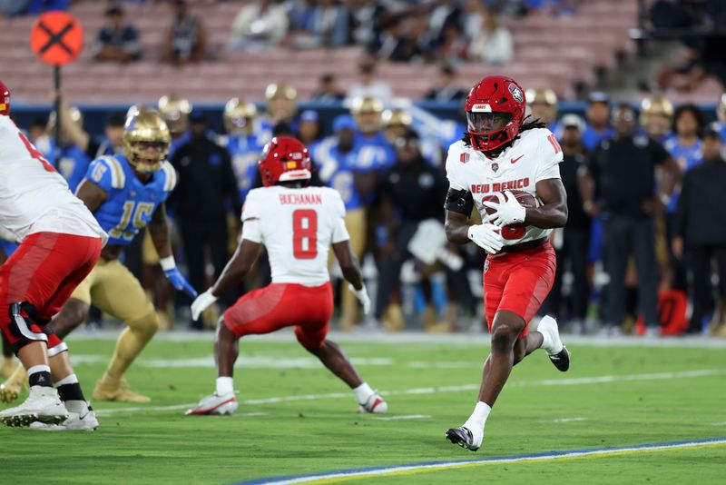 Sep 12, 2025; Pasadena, California, USA; New Mexico Lobos wide receiver Evan Wysong (10) runs with the ball during the first quarter against the UCLA Bruins at Rose Bowl. Mandatory Credit: Kiyoshi Mio-Imagn Images