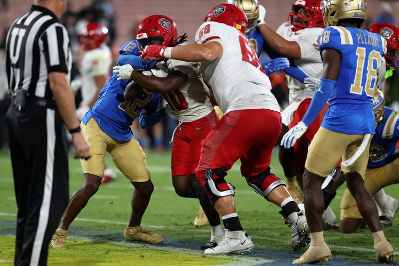 Sep 12, 2025; Pasadena, California, USA; New Mexico Lobos running back D.J. McKinney (10) scores a touchdown during the fourth quarter against the UCLA Bruins at Rose Bowl. Mandatory Credit: Kiyoshi Mio-Imagn Images