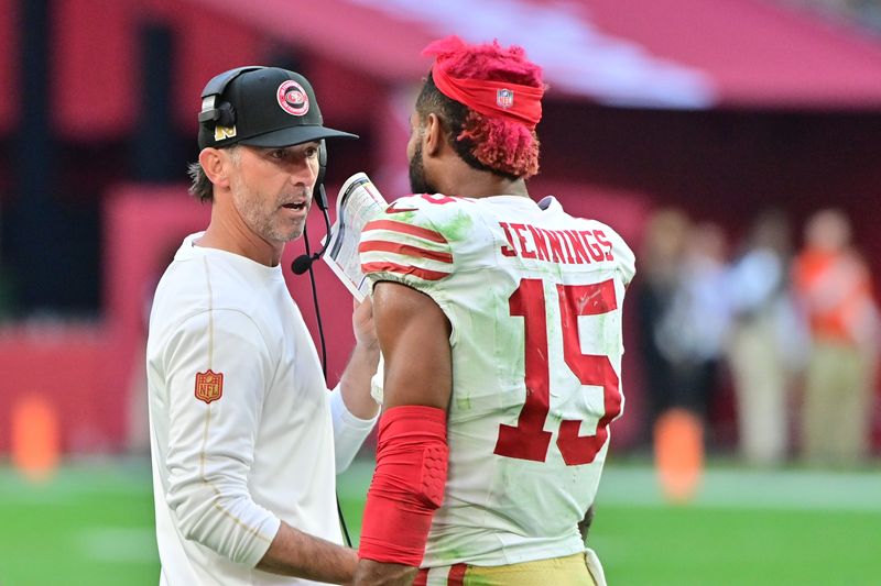 Jan 5, 2025; Glendale, Arizona, USA; San Francisco 49ers wide receiver Jauan Jennings (15) talks with head coach Kyle Shanahan after being ejected in the first half against the Arizona Cardinals at State Farm Stadium. Mandatory Credit: Matt Kartozian-Imagn Images