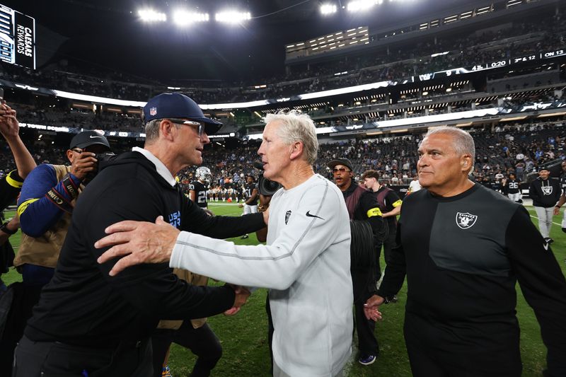 Sep 15, 2025; Paradise, Nevada, USA; Las Vegas Raiders head coach Pete Carroll and Los Angeles Chargers head coach Jim Harbaugh shake hands after the game at Allegiant Stadium. Mandatory Credit: Kiyoshi Mio-Imagn Images