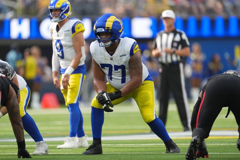 Sep 7, 2025; Inglewood, California, USA; Los Angeles Rams offensive tackle Alaric Jackson (77) wears a Guardian helmet cap in the second half against the Houston Texans at SoFi Stadium. Mandatory Credit: Kirby Lee-Imagn Images