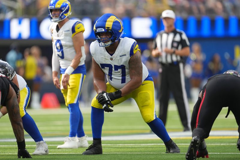 Sep 7, 2025; Inglewood, California, USA; Los Angeles Rams offensive tackle Alaric Jackson (77) wears a Guardian helmet cap in the second half against the Houston Texans at SoFi Stadium. Mandatory Credit: Kirby Lee-Imagn Images