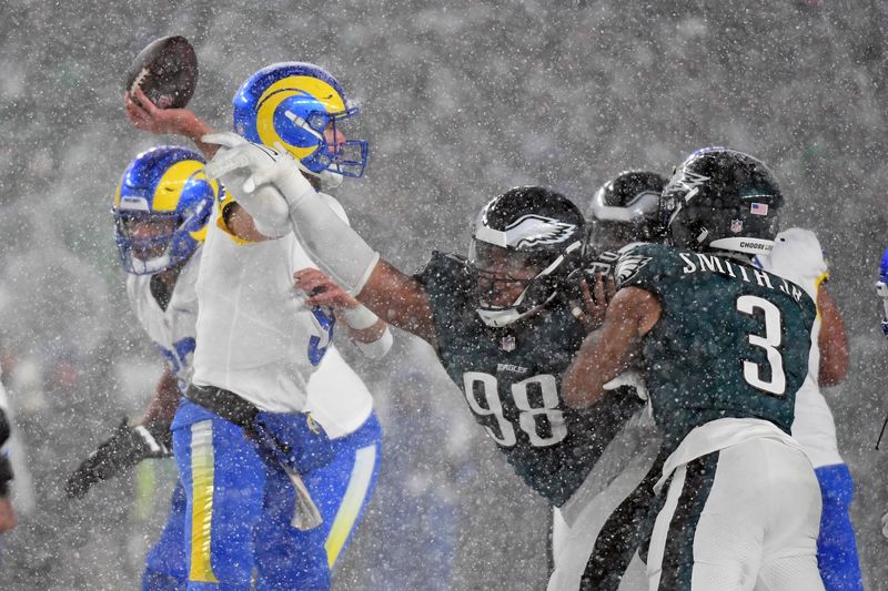Jan 19, 2025; Philadelphia, Pennsylvania, USA;Los Angeles Rams quarterback Matthew Stafford (9) is pressured by Philadelphia Eagles defensive tackle Jalen Carter (98) during the fourth quarter in a 2025 NFC divisional round game at Lincoln Financial Field. Mandatory Credit: Eric Hartline-Imagn Images