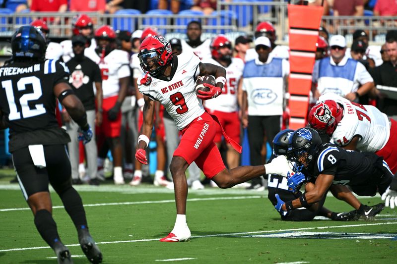 Sep 20, 2025; Durham, North Carolina, USA; North Carolina State Wolfpack wide receiver Terrell Anderson (9) runs the ball past Duke Blue Devils saftey DaShawn Stone (8) during the first quarter at Wallace Wade Stadium. Mandatory Credit: Zachary Taft-Imagn Images