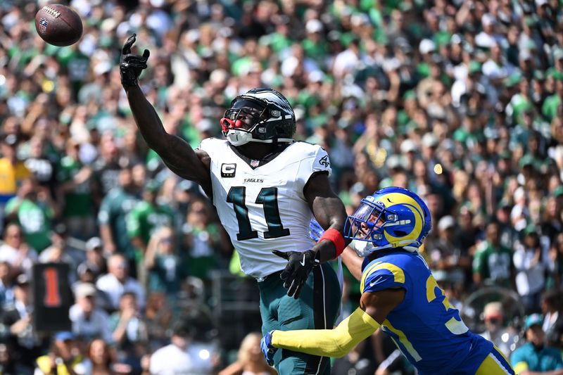Sep 21, 2025; Philadelphia, Pennsylvania, USA; Philadelphia Eagles wide receiver AJ. Brown (11) attempts to make a catch against Los Angeles Rams cornerback Darious Williams (31) during the first half at Lincoln Financial Field. Mandatory Credit: Eric Hartline-Imagn Images