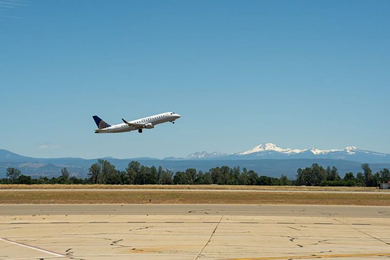 An airplane lifts off the runway at Redding Regional Airport.