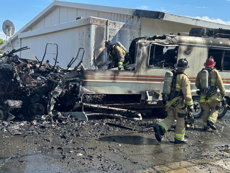 Redding firefighters mop up a fire that destroyed an RV at a Redding gas station on Thursday, Sept. 25, 2025.