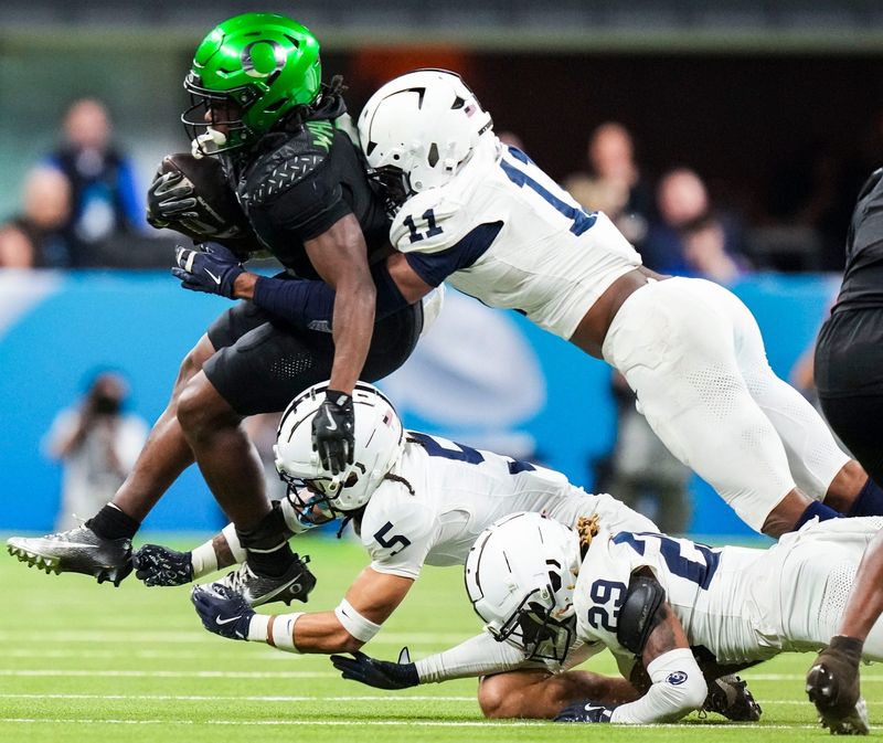 Oregon Ducks running back Noah Whittington (6) carries the ball Saturday, Dec. 7, 2024, during the Big Ten Championship game between the Oregon Ducks and the Penn State Nittany Lions at Lucas Oil Stadium in Indianapolis. The Ducks defeated the Nittany Lions, 45-37.