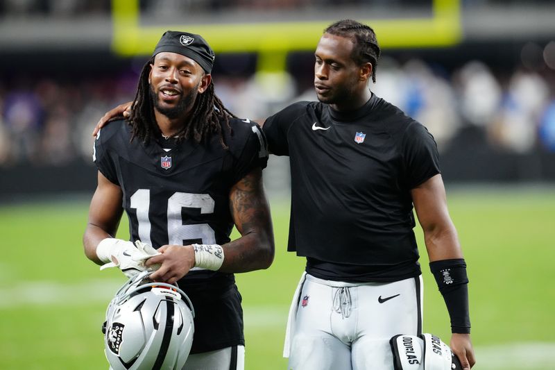 Sep 15, 2025; Paradise, Nevada, USA; Las Vegas Raiders wide receiver Jakobi Meyers (16) and Las Vegas Raiders quarterback Geno Smith (7) walk off the field after the game at Allegiant Stadium. Mandatory Credit: Stephen R. Sylvanie-Imagn Images