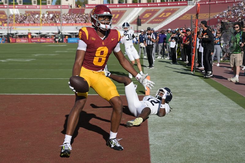 Sep 6, 2025; Los Angeles, California, USA; USC Trojans wide receiver Ja'Kobi Lane (8) celebrates after a touchdown catch in front of Georgia Southern Eagles defensive back Tracy Hill Jr. (12) during the first quarter at United Airlines Field at Los Angeles Memorial Coliseum. Mandatory Credit: Jayne Kamin-Oncea-Imagn Images