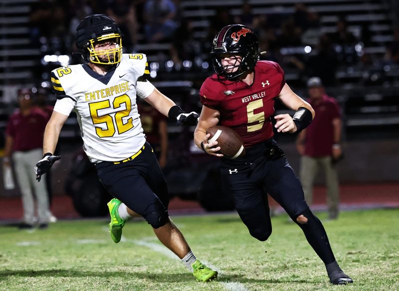 Enterprise’s Anthony Reynoso, left, pursues West Valley quarterback Kale Springer in their game on Sept. 26, 2025, in Cottonwood. West Valley defeated Enterprise 48-12.