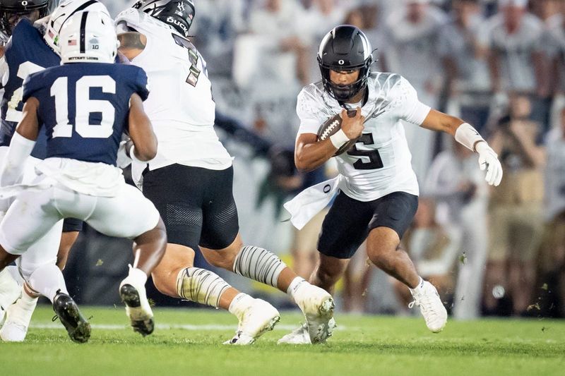 Oregon quarterback Dante Moore carries the ball as the Oregon Ducks face the Penn State Nittany Lions on Sept. 27, 2025, at Beaver Stadium in University Park, Pennsylvania.