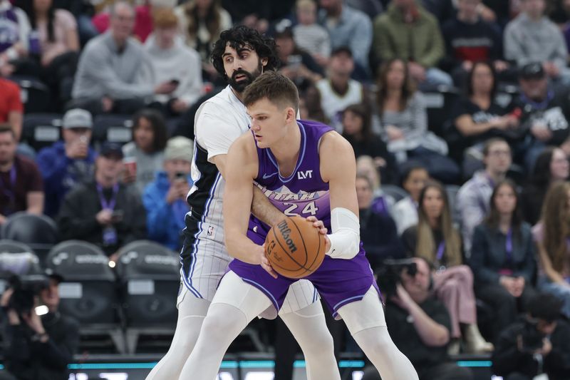 Feb 1, 2025; Salt Lake City, Utah, USA; Utah Jazz center Walker Kessler (24) keeps the ball away from Orlando Magic center Goga Bitadze (35) during the first quarter at Delta Center. Mandatory Credit: Chris Nicoll-Imagn Images