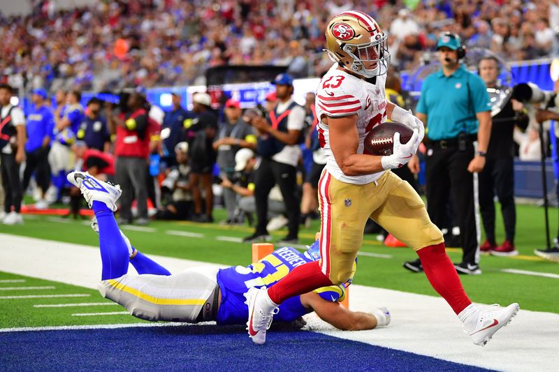 Oct 2, 2025; Inglewood, California, USA; San Francisco 49ers running back Christian McCaffrey (23) rushes the ball for a touchdown against the Los Angeles Rams during the first half at SoFi Stadium. Mandatory Credit: Gary A. Vasquez-Imagn Images