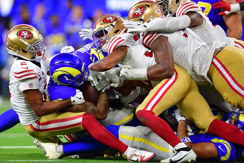 Oct 2, 2025; Inglewood, California, USA; Los Angeles Rams running back Kyren Williams (23) is tackled for no gain on fourth down to end the game against the San Francisco 49ers during overtime at SoFi Stadium. Mandatory Credit: Gary A. Vasquez-Imagn Images