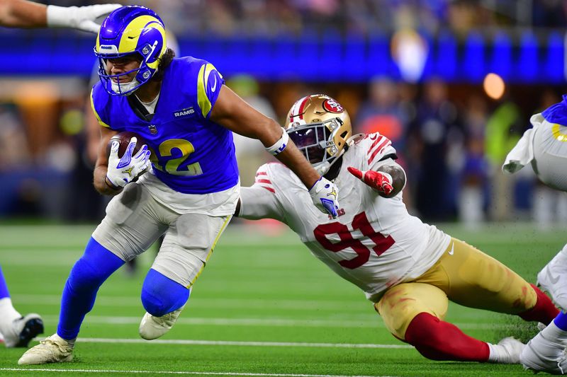 Oct 2, 2025; Inglewood, California, USA; Los Angeles Rams wide receiver Puka Nacua (12) makes a catch past San Francisco 49ers defensive tackle Sam Okuayinonu (91) during the second half at SoFi Stadium. Mandatory Credit: Gary A. Vasquez-Imagn Images