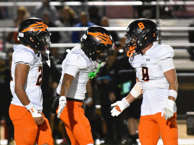 Apple Valley's Chase Higgs, right, celebrates with teammates after recording a tackle for a loss of yards during the fourth quarter on Thursday, Oct. 2, 2025.