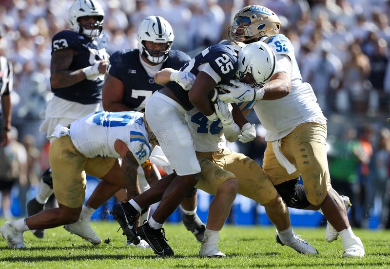 Oct 5, 2024; University Park, Pennsylvania, USA; Penn State Nittany Lions running back Quinton Martin Jr (25) runs with the ball on a return during the fourth quarter against the UCLA Bruins at Beaver Stadium. Mandatory Credit: Matthew O'Haren-Imagn Images