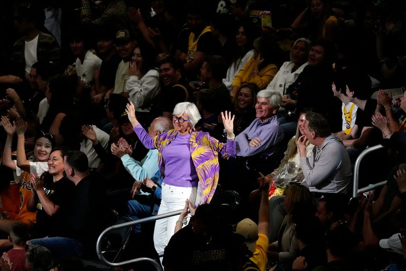A Los Angeles Lakers fan dances while being featured on the big screen during a break in the preseason NBA game with the Phoenix Suns at Acrisure Arena in Palm Desert, Calif., on Friday, Oct. 3, 2025.