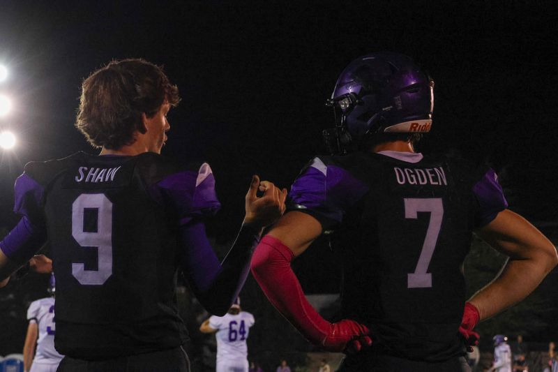 Redding Christian's Wyatt Shaw (#9) and Brodie Ogden (#7) talk things over on the sidelines during a game against Modoc. Oct. 3, 2025.