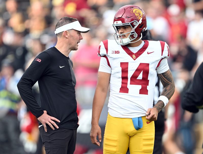 Sep 13, 2025; West Lafayette, Indiana, USA; Southern California Trojans quarterback Jayden Maiava (14) talks with Southern California Trojans head coach Lincoln Riley before the game against the Purdue Boilermakers at Ross-Ade Stadium. Mandatory Credit: Marc Lebryk-Imagn Images