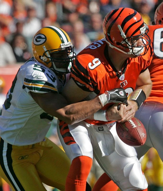 Cincinnati Bengals' QB Carson Palmer fumbles the ball after getting sacked by Green Bay Packers linebacker Paris Lenon during the Bengals 21-14 victory over the Packers at Paul Brown Stadium in Cincinnati on October 30, 2005.