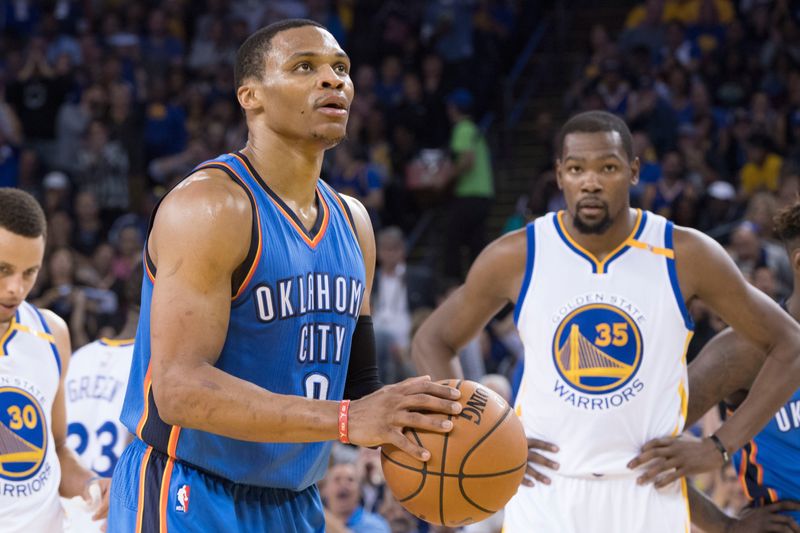 November 3, 2016; Oakland, CA, USA; Oklahoma City Thunder guard Russell Westbrook (0) shoots a technical foul shot as Golden State Warriors forward Kevin Durant (35) looks on during the second quarter at Oracle Arena. Mandatory Credit: Kyle Terada-USA TODAY Sports