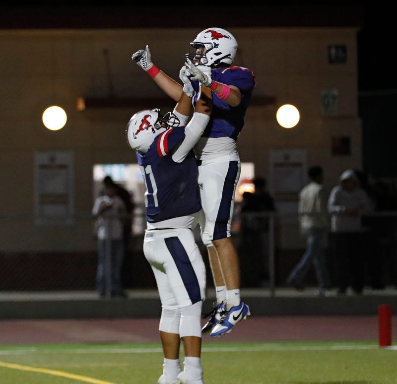 Tulare Western's Grant Crawford is hoisted after scoring a touchdown against Dinuba during their West Yosemite League high school football game Bob Mathias Stadium in Tulare, Calif., Thursday, Oct. 9, 2025.