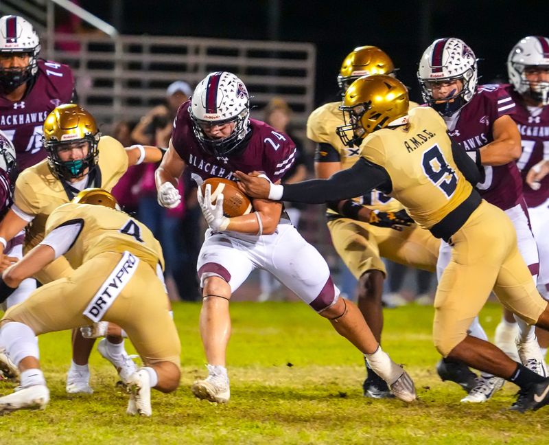 La Quinta's Colton LaCrone carries the ball as a number of Saints close in for a hit during the first quarter of their game in La Quinta, Calif., Friday, Oct. 10, 2025.