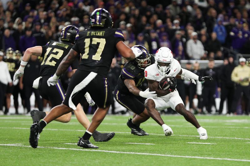 Oct 10, 2025; Seattle, Washington, USA; Rutgers Scarlet Knights wide receiver DT Sheffield (0) is brought down by Washington Huskies linebacker Xe'ree Alexander (10) during the first half at Husky Stadium. Mandatory Credit: Kevin Ng-Imagn Images