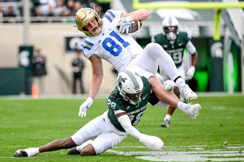 Michigan State's Dontavius Nash, below, tackles UCLA's Hudson Habermehl during the first quarter on Saturday, Oct. 11, 2025, at Spartan Stadium in East Lansing.
