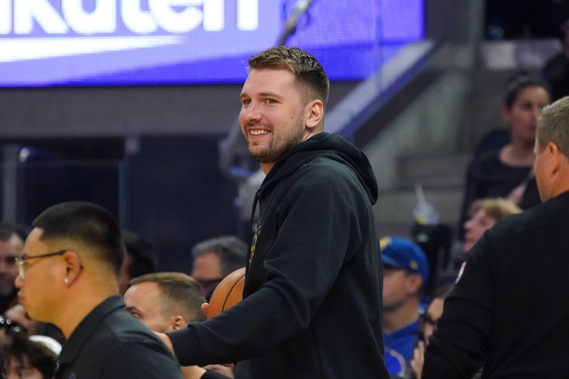 Oct 5, 2025; San Francisco, California, USA; Los Angeles Lakers forward/guard Luka Doncic (77) smiles from the sidelines during the second quarter against the Golden State Warriors at Chase Center. Mandatory Credit: David Gonzales-Imagn Images